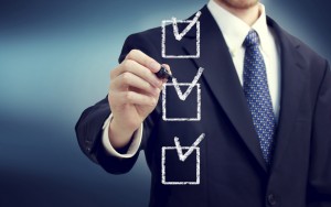 Business man with check boxes over navy blue background